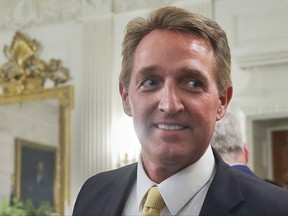 FILE - In this July 19, 2017 photo, Sen. Jeff Flake, R-Ariz. walks to his seat as he attends a luncheon with other GOP Senators and President Donald Trump at the White House in Washington. When President Trump takes the stage this week at a rally in Phoenix, Arizona, the state's junior senator will be nowhere to be seen. But Trump is likely to save some choice words for Sen. Flake (AP Photo/Pablo Martinez Monsivais)