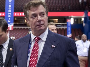 FILE - In this July 18, 2016 file photo, then-Trump campaign chairman Paul Manafort walks around the convention floor before the opening session of the Republican National Convention in Cleveland. A spokesman for President Donald Trump's former campaign chairman, Paul Manafort, says that FBI agents served a search warrant at one of his homes.  (AP Photo/Carolyn Kaster, File)