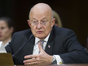 FILE - In this Jan. 10, 2017 file photo, then-National Intelligence Director James Clapper testifies on Capitol Hill in Washington. President Donald Trump and Clapper, the former national intelligence chief, are trading verbal barbs that started after Clapper questioned Trump's fitness to be in the Oval Office.  (AP Photo/Cliff Owen, File)