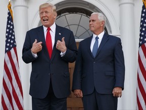 In this Aug. 10, 2017, photo, President Donald Trump, accompanied by Vice President Mike Pence, speaks to reporters before a security briefing at Trump National Golf Club in Bedminster, N.J. Pence departs Sunday for Latin America, a trip that comes on the heels of yet another provocative statement fromTrump that Pence is sure to have to answer for: this time Trump's sudden declaration that he would not rule out a "military option" in Venezuela, where president Nicolas Maduro has been consolidating power, plunging the country into chaos. (AP Photo/Evan Vucci)