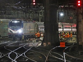 FILE - In this July 9, 2017 file photo, Amtrak workers continue ongoing infrastructure renewal work beneath Penn Station in New York. President Donald Trump's road to getting legislation through Congress this year to restore the nation's crumbling infrastructure appears increasingly precarious. (AP Photo/Kathy Willens, File)