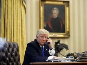 FILE - In this Jan. 28, 2017 file photo, President Donald Trump speaks on the phone with Prime Minister of Australia Malcolm Turnbull in the Oval Office of the White House in Washington. (AP Photo/Alex Brandon, File)