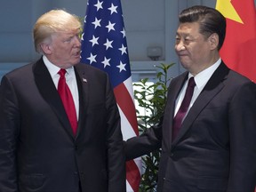 FILE - In this July 8, 2017, file photo, U.S. President Donald Trump, left, and China's President Xi Jinping arrive for a meeting on the sidelines of the G-20 Summit in Hamburg, Germany. Trump is planning to sign an executive action asking the U.S. Trade Representative to consider investigating China for the theft of U.S. technology and intellectual property. He is taking the step even as he seeks China's help with the ongoing crisis with North Korea. (Saul Loeb/Pool Photo via AP, File)