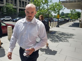 FILE - In this June 11, 2014 file photo, former Blackwater Worldwide guard Nicholas Slatten leaves federal court in Washington. A federal appeals court on Friday, Aug. 4, 2017, overturned the first-degree murder conviction of a Slatten, ordering a new trial for the man prosecutors say fired the first shots in the 2007 slayings of 14 Iraqi civilians at a crowded traffic circle in Baghdad.  (AP Photo/Cliff Owen, File)