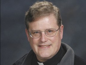 In this photo provided by the Catholic Diocese of Arlington, Va., Father William Aitcheson, a priest in the Roman Catholic Diocese of Arlington. Aitcheson is taking a leave of absence after disclosing he once was a member of the Ku Klux Klan. Aitcheson wrote about his past Klan affiliation Monday, Aug. 21, 2017, in The Arlington Catholic Herald, the diocese's newspaper. (Catholic Diocese of Arlington, Va. via AP