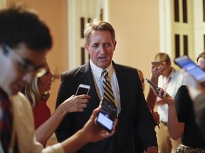 FILE - In this July 13, 2017, file photo, Sen. Jeff Flake, R-Ariz. speaks to members of the media as he walks to a meeting on Capitol Hill in Washington. There wasn't a dramatic public break, or a precise moment when it happened. But little by little, Senate Republicans have been turning their backs on President Donald Trump. They've defied his Twitter demands, defeated his top agenda item and passed veto-proof sanctions on Russia over administration objections. Flake took aim at Trump and his own party in a new book, writing that "Unnerving silence in the face of an erratic executive branch is an abdication" and "the strange specter of an American president's seeming affection for strongmen and authoritarians created such a cognitive dissonance among my generation of conservatives _ who had come of age under existential threat from the Soviet Union _ that it was almost impossible to believe." (AP Photo/Pablo Martinez Monsivais, File)