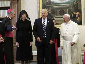 FILE - In this May 24, 2017 file-pool photo, President Donald Trump and first lady Melania Trump meet with Pope Francis at the Vatican. Sean Spicer finally got to meet the Pope. Vatican spokesman Greg Burke confirms the former White House press secretary attended a meeting with Pope Francis on Sunday, Aug. 27, 2017. Spicer, who is Roman Catholic, had been left off a list of White House officials who had the chance to meet with Pope Francis in May when Trump visited the Vatican. (AP Photo/Evan Vucci, Pool, File)