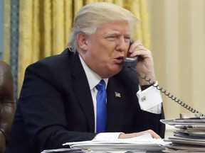 In this photo taken Jan. 28, 2017, President Donald Trump speaks on the phone with Australian Prime Minister Malcolm Turnbull in the Oval Office of the White House in Washington. Transcripts of President Donald Trump's conversations with the leaders of Mexico and Australia in January offer new details on how the president parried with the leaders over the politics of the border wall and refugee policy, with random asides on subjects including drug abuse in New Hampshire. (AP Photo/Alex Brandon)