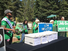 Fed Up, a group representing community activists, labor unions and liberal policy groups, holds a protest rally Friday, August 25, 2017, outside the conference site for a three-day meeting of central bankers in Jackson Hole, Wyoming. The group presented petitions with more than 20,000 signatures demanding that President Donald Trump re-nominate Janet Yellen for a second term as chair of the Federal Reserve. Some protesters dressed as Janet Yellen super heroes complete with green capes and Yellen's signature white hair. (AP Photo/Martin Crutsinger)