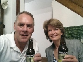 In this photo provided by the office of Interior Secretary Ryan Zinke, taken, Wednesday, Aug. 2, 2017, Zinke and Sen. Lisa Murkowski, R-Alaska enjoy Alaskan beer in Washington. Zinke says he's mended fences with Murkowski after a widely reported dispute over Murkowski's vote to oppose the GOP health care bill. Zinke tweeted a photo of the two enjoying the beers at his Washington home. (Office of Interior Secretary Ryan Zinke via AP)