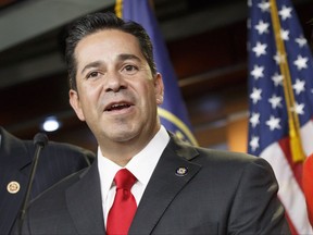 FILE - In this Nov. 17, 2014 file photo, Rep. Ben Ray Lujan, D-N.M. speaks during a news conference on Capitol Hill in Washington. The House Ethics Committee said Tuesday, Aug. 1, 2017, it is dropping separate investigations against Democratic Rep. Ben Ray Lujan of New Mexico and Republican Rep. Roger Williams of Texas.  (AP Photo/J. Scott Applewhite, File)