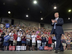In this Aug. 3, 2017, photo, President Donald Trump arrives to speak at a campaign-style rally at Big Sandy Superstore Arena in Huntington, W.Va. After six months of infighting, investigations and legislative failures, President Donald Trump is trying to combat new signs of weakness in his Republican base and re-energize his staunchest supporters. White House officials have been urging the president to refocus on immigration and other issues that resonate with the conservatives, evangelicals and working-class whites who propelled him to the Oval Office. The president has ramped up his media-bashing via Tweet, long a successful tactic for Trump, and asked his base to rally to his defense.(AP Photo/Susan Walsh)
