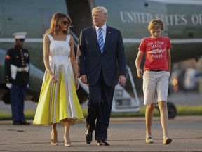 FILE - In this Aug. 20, 2017 file photo, President Donald Trump, first lady Melania Trump and son Barron Trump walk across the tarmac before boarding Air Force One at Morristown Municipal Airport in Morristown, N.J., for the return flight to the Washington. The White House is appealing to the news media for privacy for President Donald Trump's young son, Barron.  (AP Photo/Pablo Martinez Monsivais, File)