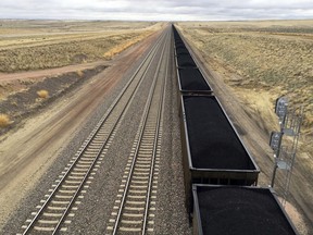 FILE - In this March 28, 2017, file photo, a train near hauls coal mined from Wyoming's Powder River Basin near Bill, Wyo. he Interior Department has scrapped an Obama-era rule aimed at ensuring that coal companies don't shortchange taxpayers on huge volumes of coal extracted from public lands, primarily in the West. (AP Photo/Mead Gruver, File)