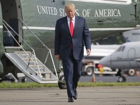 FILE - In this Aug. 14, 2017 file photo, President Donald Trump walks across the tarmac from Marine One to board Air Force One at Morristown Municipal Airport in Morristown, N.J. Bombarded by the sharpest attacks yet from fellow Republicans, President Donald Trump on Thursday, Aug. 17, 2017, dug into his defense of racist groups by attacking members of own party and renouncing the rising movement to pull down monuments to Confederate icons. (AP Photo/Pablo Martinez Monsivais, File)