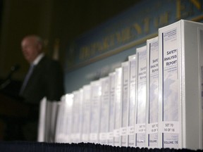 FILE - In this June 3, 2008 file photo, The Yucca Mountain License application is seen the National Press Club in Washington. The Nuclear Regulatory Commission (NRC) has begun work to prepare for the Trump administration's bid to revive the long-dormant nuclear waste dump at Nevada's Yucca Mountain. The nuclear agency says it will spend up to $110,000 from its current budget to gather documents and other information from an administrative hearing suspended six years ago after the Obama administration abandoned plans for the Yucca Mountain site. (AP Photo/Lawrence Jackson, File)