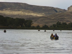 FILE - In this Sept. 19, 2011 file photo, a group canoes through the Upper Missouri River Breaks National Monument near Fort Benton, Mont. Interior Secretary Ryan Zinke says he will not recommend changes to Montana's Upper Missouri River Breaks National Monument as he continues to review national monuments for possible elimination or reduction.  (AP Photo/Matthew Brown, File)