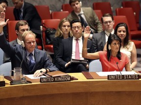 In this Aug. 5, 2017, photo, British Ambassador to the United Nations Matthew Rycroft, left, and U.S. Ambassador to the United Nations Nikki Haley vote during a Security Council meeting on a new sanctions resolution that would increase economic pressure on North Korea to return to negotiations on its missile program at U.N. headquarters. The strongest U.N. sanctions in a generation may still prove no match for North Korea's relentless nuclear weapons ambitions. Even in diplomatic triumph, the Trump administration is gambling that it has enough time to test if economic pressure can get Kim Jong Un's totalitarian government to end its missile advances and atomic weapons tests (AP Photo/Mary Altaffer)