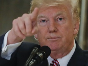 In this Aug. 15, 2017, photo, President Donald Trump points to members of the media as he answers questions in the lobby of Trump Tower in New York. Republican leaders on Wednesday tiptoed around Trump's extraordinary comments on white supremacists.  (AP Photo/Pablo Martinez Monsivais)