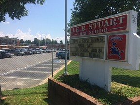 FILE - In this July 20, 2017 file photo, the sign for J.E.B. Stuart High School in Falls Church, Va., named after the slaveholding Confederate general who was mortally wounded in an 1864 battle. With a new school year dawning, education officials around the nation are grappling with whether to remove the names, images and statues of Confederate figures from public schools, some of whom are now filled with students of color who could be descendants of those whom the South fought to keep in slavery. (AP Photo/Matt Barakat)