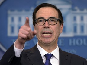 FILE - In this July 31, 2017, file photo, Treasury Secretary Steven Mnuchin calls on a reporter during the daily briefing at the White House in Washington. The Trump administration and Congress face a daunting set of budget-related deadlines in the coming weeks. Blowing them could upend global financial markets and cause a partial government shutdown. (AP Photo/Susan Walsh, File)