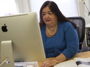 In this March 24, 2014 file photo, Jane Delgado, president of the National Alliance for Hispanic Health, works in her office in Washington. U.S. Hispanics have longer life expectancy, but a new poll finds few older Latinos are confident that nursing homes and assisted living facilities can meet their needs.  (AP Photo/ Evan Vucci)