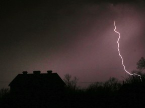 FILE - In this March 6, 2017 file photo, lightning strikes near the barn on the Taylor farm near Lawrence, Kan.  Lightning used to kill about 300 Americans a year, but lightning deaths are on pace to hit a record low this year. Scientists say less time spent outside and improved medical treatment have contributed to fewer deaths.  (AP Photo/Orlin Wagner, File)