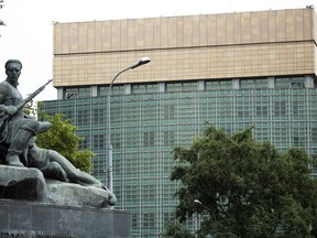 FILE - In this July 28, 2017, file photo, the U.S. Embassy in Moscow, with a monument to Russian revolutionary workers in the foreground. President Donald Trump on Aug. 2, signed what he called a "seriously flawed" bill imposing new sanctions on Russia, pressured by his Republican Party not to move on his own toward a warmer relationship with Moscow in light of Russian actions. Moscow has responded to a White House announcement that Trump intended to sign the bill, by ordering a reduction in the number of U.S. diplomats in Russia. (AP Photo/Alexander Zemlianichenko, File)