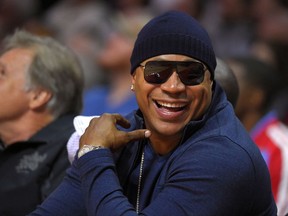 FILE - In this Nov. 3, 2014 file photo, rapper/actor LL Cool J watches the Los Angeles Clippers play the Utah Jazz during the first half of an NBA basketball game, in Los Angeles. The John F. Kennedy Center for the Performing Arts announced the recipients of the 2017 Kennedy Center Honors. They are: hip-hop artist LL Cool J, singers Gloria Estefan and Lionel Richie, television writer and producer Norman Lear and dancer Carmen de Lavallade. It's the 40th year of the awards, which honor people who have influenced American culture through the arts.  (AP Photo/Mark J. Terrill, File)