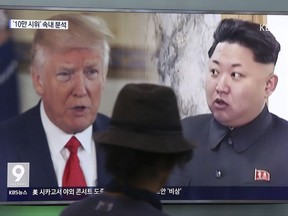 A man watches a television screen showing President Donald Trump and North Korean leader Kim Jong Un during a news program at the Seoul Train Station in Seoul, South Korea, Thursday, Aug. 10, 2017.