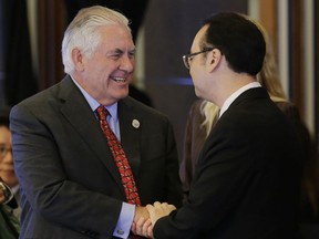 U.S. State Secretary Rex Tillerson, left, is greeted by Philippine Foreign Affairs Secretary Allan Peter Cayetano at the start of the 7th East Asia Summit Foreign Ministers' Meeting in Manila, Philippines on Monday, Aug. 7, 2017. (AP Photo/Aaron Favila, Pool)