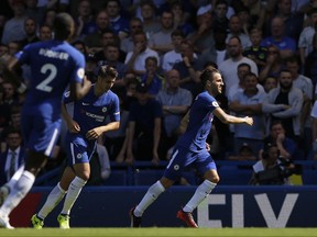 Chelsea's Cesc Fabregas, right, celebrates after scoring the opening goal during the English Premier League soccer match between Chelsea and Everton at Stamford Bridge stadium in London, Sunday, Aug. 27, 2017. (AP Photo/Alastair Grant)