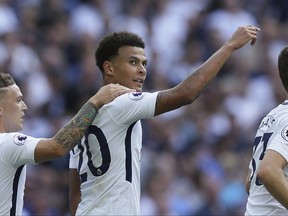 Tottenham Hotspur's Dele Alli, center, celebrates after scoring the opening goal during the English Premier League soccer match between Tottenham Hotspur and Burnley at Wembley stadium in London, Sunday, Aug. 27, 2017. (AP Photo/Tim Ireland)
