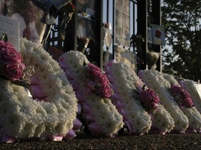 A flora tribute for the late Diana, Princess of Wales, near an ornamental gate outside the Kensington Palace in London, Thursday, Aug. 31, 2017. The tributes are to mark the 20th anniversary of Princess Diana's death in a car crash in Paris Aug. 31, 1997. (AP Photo/Alastair Grant)