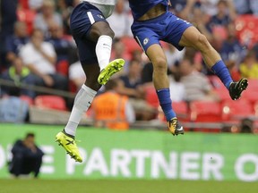 Chelsea's Marcos Alonso, right, vies for the ball with Tottenham Hotspur's Victor Wanyama during their English Premier League soccer match between Tottenham Hotspur and Chelsea at Wembley stadium in London, Sunday, Aug. 20, 2017.Chelsea won the game 2-1. (AP Photo/Alastair Grant)