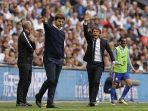 Chelsea's manager Antonio Conte, right, and Tottenham Hotspur's manager Mauricio Pochettino gestures to their players during their English Premier League soccer match between Tottenham Hotspur and Chelsea at Wembley stadium in London, Sunday, Aug. 20, 2017. Chelsea won the match 2-1. (AP Photo/Alastair Grant)