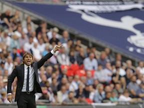 Chelsea's manager Antonio Conte gestures towards his players during their English Premier League soccer match between Tottenham Hotspur and Chelsea at Wembley stadium in London, Sunday, Aug. 20, 2017. Chelsea won the match 2-1. (AP Photo/Alastair Grant)