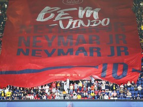 PSG fans welcome Brazilian soccer star Neymar at the Parc des Princes stadium in Paris, Saturday, Aug. 5, 2017, during his official presentation to fans ahead of Paris Saint-Germain's season opening match against Amiens. Neymar would not play in the club's season opener as the French football league did not receive the player's international transfer certificate before Friday's night deadline. The Brazil star became the most expensive player in soccer history after completing his blockbuster transfer from Barcelona for 222 million euros ($262 million) on Thursday. (AP Photo/Francois Mori)