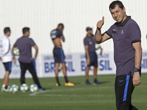 In this July 28, 2017 photo, Corinthians soccer coach Fabio Carille gives a thumbs up, during his team's training session in Sao Paulo, Brazil. Before coaching, Carille played for several small clubs from Sao Paulo state so he could be closer to his family. Less than 10 years ago he started his coaching career as an assistant at tiny Barueri, the club where he ended his career at 33 years of age. Corinthians brought him to their staff in 2009.  (AP Photo/Andre Penner)