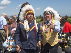 Perry Bellegarde, left, national chief of the Assembly of First Nations, chats with Morley Googoo, regional chief for Nova Scotia and Newfoundland, at a meeting of Atlantic MPs and First Nations chiefs in Wolfville, N.S. on Thursday, Aug. 10, 2017. THE CANADIAN PRESS/Andrew Vaughan