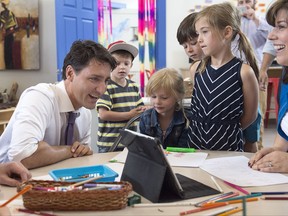 Prime Minister Justin Trudeau chats with children as he visits Wee College daycare and early learning centre in Moncton, N.B. on Wednesday, Aug. 30, 2017. THE CANADIAN PRESS/Andrew Vaughan