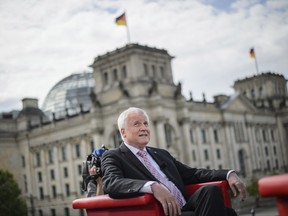 Bavarian governor, Horst Seehofer, answers questions during an interview with German TV broadcaster ARD in Berlin, Germany, Sunday, Aug. 20, 2017. In background the parliament building, the Reichstag.  (Gregor Fischer/dpa via AP)