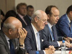 FILE - This July 14, 2017 file photo, the Special Envoy of the Secretary-General for Syria Staffan de Mistura, second left, attends a round of negotiation with Syria's main opposition High Negotiations Committee (HNC) leader Nasr al-Hariri during the Intra Syria talks, at Palais des Nations in Geneva, Switzerland. As Damascus reverses military losses in much of the country's strategically important west and foreign states cut support for rebels, diplomats from Washington to Riyadh are asking representatives of Syria's opposition to come to terms with President Bashar Assad's political survival. (Xu Jinquan/Pool Photo via AP, File)