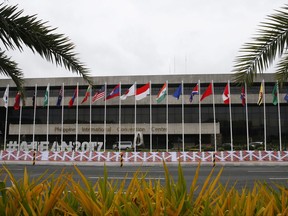 Flags flutter outside the Philippine International Convention Center, the venue for the Aug. 2-8 50th Association of Southeast Asian Nations Foreign Ministers' Meeting and its regional partners, Wednesday, Aug. 2, 2017 in suburban Pasay city, south of Manila, Philippines. An initial draft of a joint communique to be issued by the ASEAN foreign ministers, which was seen by The Associated Press on Wednesday, says they would ask senior diplomats to immediately initiate talks on the so-called code of conduct in the disputed sea after their governments agreed on a framework of the accord with China in May. (AP Photo/Bullit Marquez)
