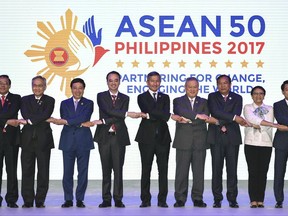 ASEAN Foreign Ministers link hands "The ASEAN Way" at the opening ceremony of the 50th ASEAN Foreign Ministers Meeting at the Philippine International Convention Center Saturday, Aug. 5, 2017 in suburban Pasay city, south of Manila, Philippines. They are, from left, Malaysia's Anifah Aman, Myanmar's U Kyaw Tin, Thailand's Don Pramudwinai, Vietnam's Pham Binh Minh, Philippines' Alan Peter Cayetano, Singapore's Vivian Balakrishnan, Brunei's Lim Jock Seng, Cambodia's Prak Sokhonn, Indonesia's Retno Marsudi, Laos' Saleumxay Kommasith and ASEAN Secretary-General Le Luong Minh. (AP Photo/Mohd Rasfan, Pool)