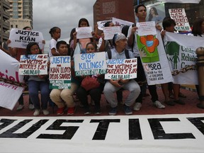 Protesters display placards during a rally to condemn the recent killings in President Rodirgo Duterte's renewed crackdown on drug offenders which also claimed the life of a minor Friday, Aug. 18, 2017, in Quezon city north of Manila, Philippines. President Rodrigo Duterte's renewed crackdown on drug offenders has resulted in some dozens of killings over the past three days alone.(AP Photo/Bullit Marquez)