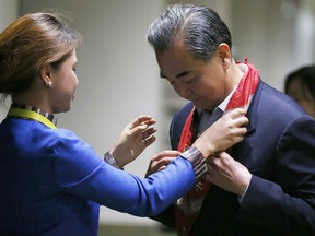 Chinese Foreign Minister Wang Yi receives a lei upon arrival to take part in the 50th ASEAN Foreign Ministers' Meeting and its Dialogue Partners, Saturday, Aug. 5, 2017, in suburban Pasay city south Manila, Philippines. Alarm over North Korea's missile tests, a tentative step to temper South China Sea disputes, and unease over a disastrous siege by pro-Islamic State group militants, will grab the spotlight at the annual meetings of Southeast Asia's top diplomats and their Asian and Western counterparts. (AP Photo/Bullit Marquez)