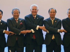 U.S. State Secretary Rex Tillerson, center, links arms with ASEAN foreign ministers as they take part in the ASEAN-U.S. Ministerial meeting in the 50th Association of Southeast Asia Nations Regional Forum in suburban Pasay city, southeast of Manila, Philippines, Sunday, Aug.6, 2017. (Erik De Castro/Pool Photo via AP)