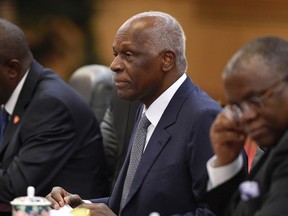 FILE - In this file photo dated Tuesday, June 9, 2015, Angolan President Jose Eduardo Dos Santos, listens during a meeting with Chinese President Xi Jinping at the Great Hall of the People in Beijing. Angolans vote Wednesday in an election that will see dos Santos quit after nearly four decades in power. (Wang Zhao/Pool Photo via AP, File)