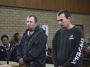 FILE -- In this Wednesday, Nov. 16, 2016 file photo Theo Jackson, left, and Willem Oosthuizen, right, appear in the Magistrates Court in Middelburg, South Africa, accused of forcing a black man into a coffin and threatening to set him on fire.  The two men have been convicted Friday Aug. 25, 2017, of attempted murder, kidnapping and other charges. (AP Photo, File)